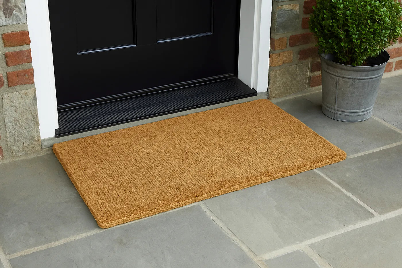 A 30 by 48 inch mat at a black front door